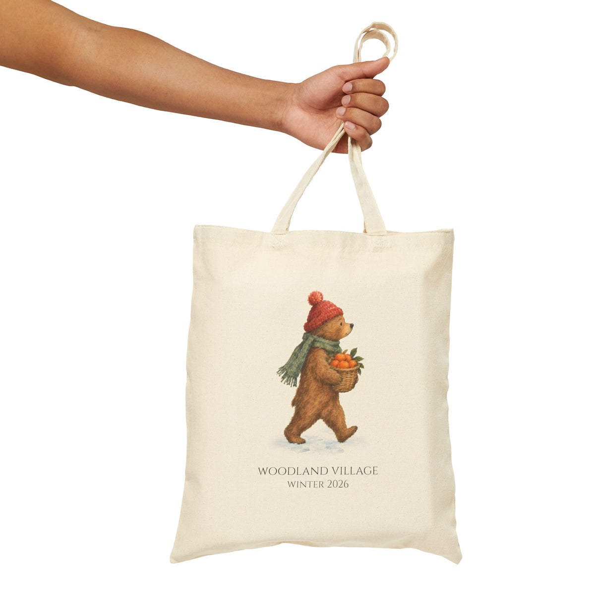 Hand holding the Woodland Bear tote by its canvas handles