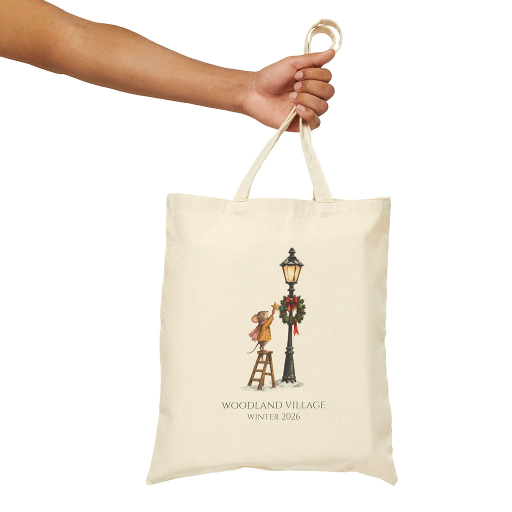 Hand holding the Woodland Mouse tote by its canvas handles