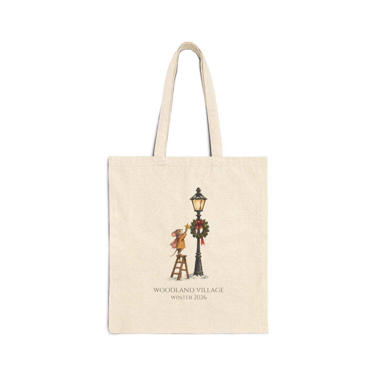 Natural canvas tote with a mouse on a ladder hanging a star by a wreathed lamppost